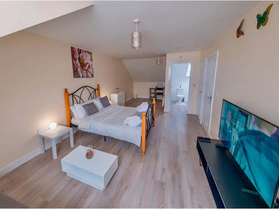 A bedroom with a bed and television at Rochester Road in Corby