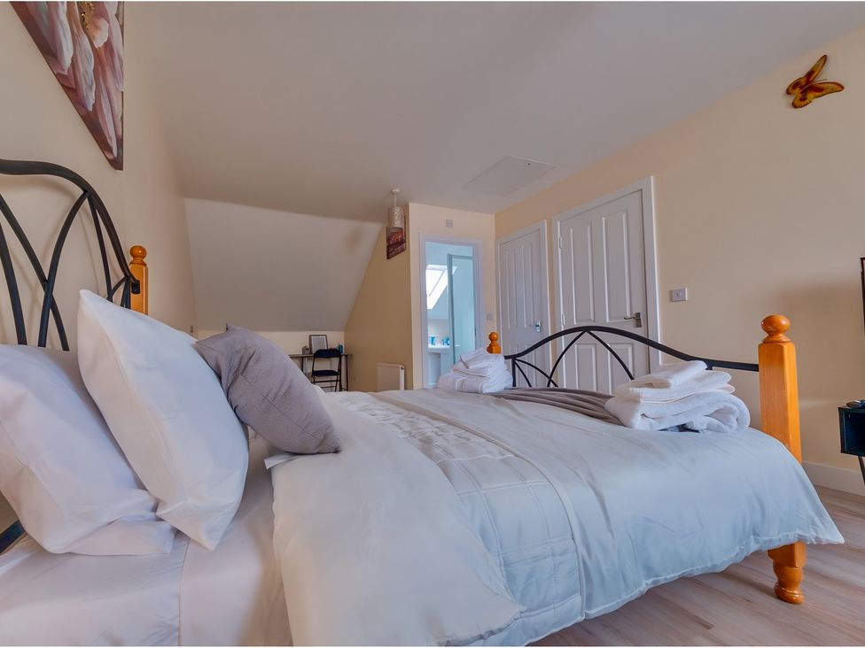 A bedroom with a bed and a chair at Rochester Road in Corby