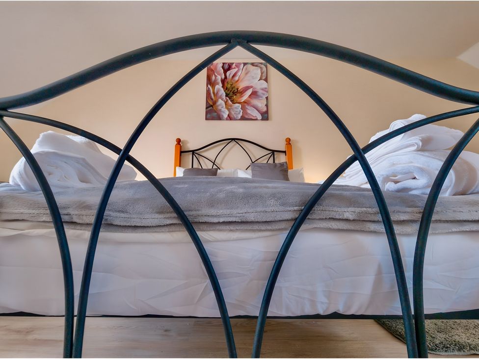 A bedroom with a bed and wall art at Rochester Road in Corby