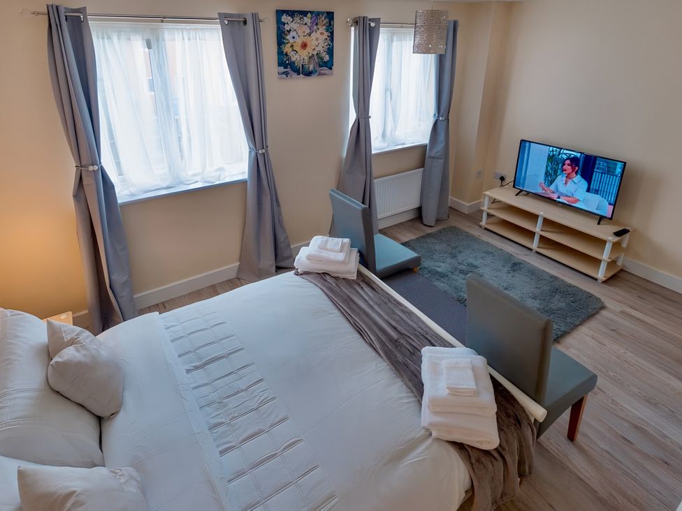 A bedroom with a bed and tv at Rochester Road in Corby