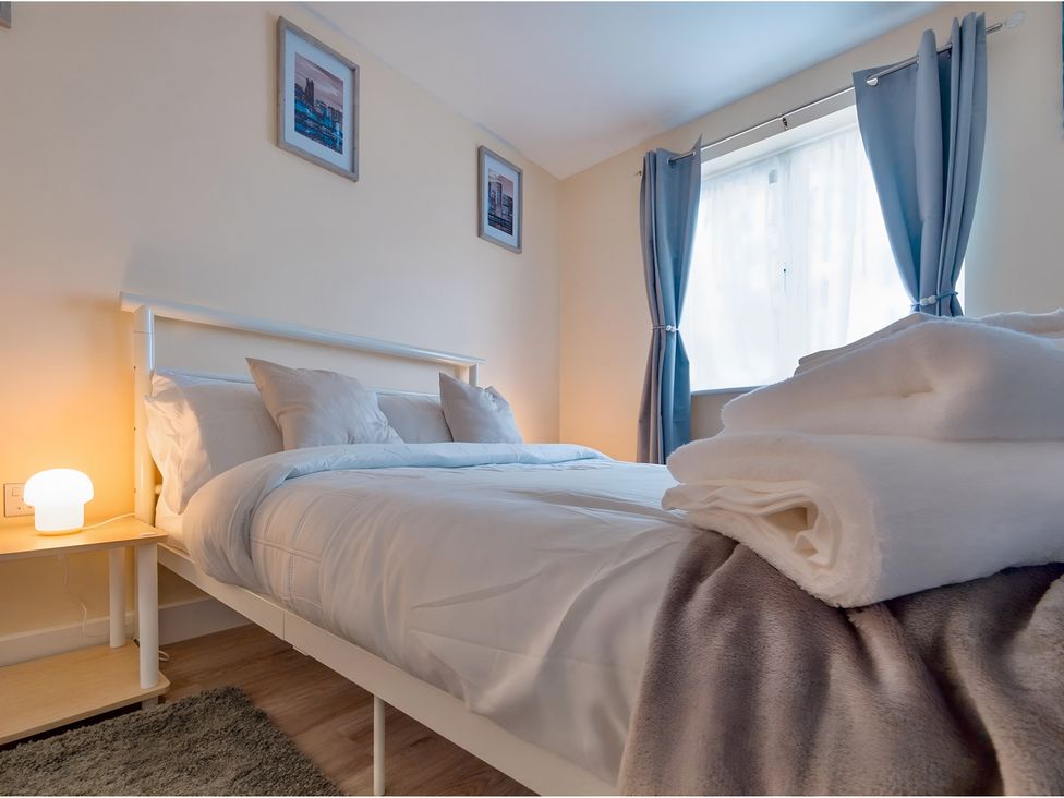 A bedroom with a bed and bedside table at Rochester Road in Corby