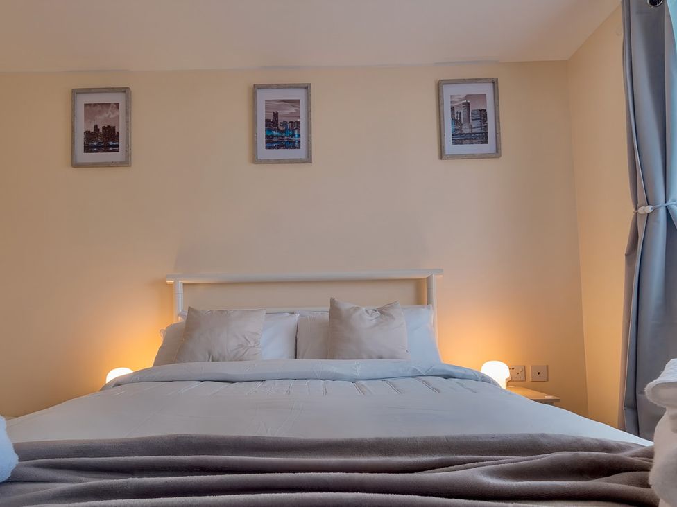 A bedroom with a bed and wall art at Rochester Road in Corby