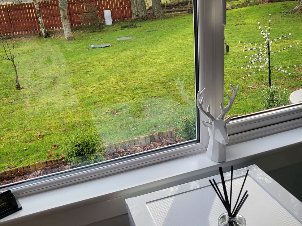 A view of a garden with a decorative object on a table at Taigh Nam Moireach in Inverness