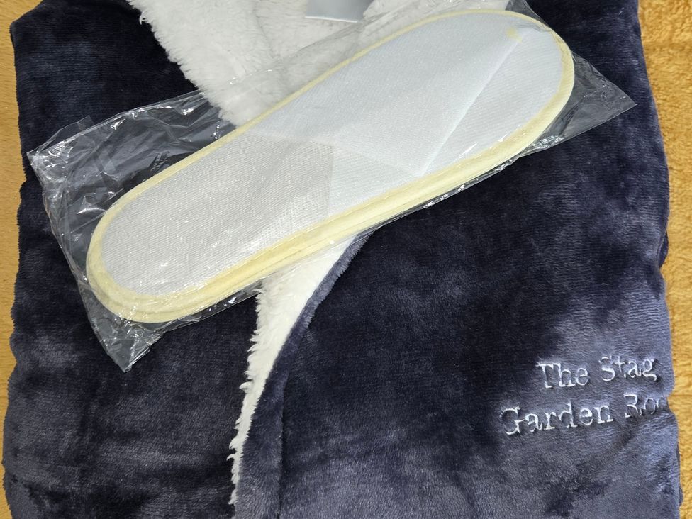 A robe and slippers with embroidery at The Stag Garden Room in Inverness