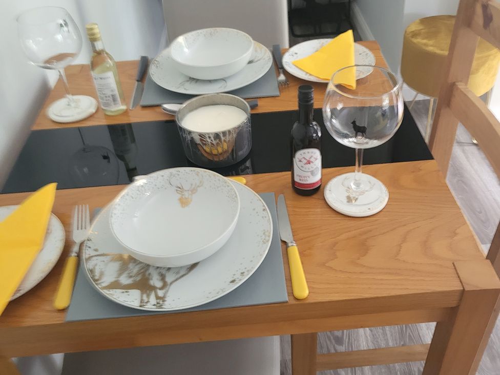 A dining table set with plates and glasses at Taigh Nam Moireach in Inverness
