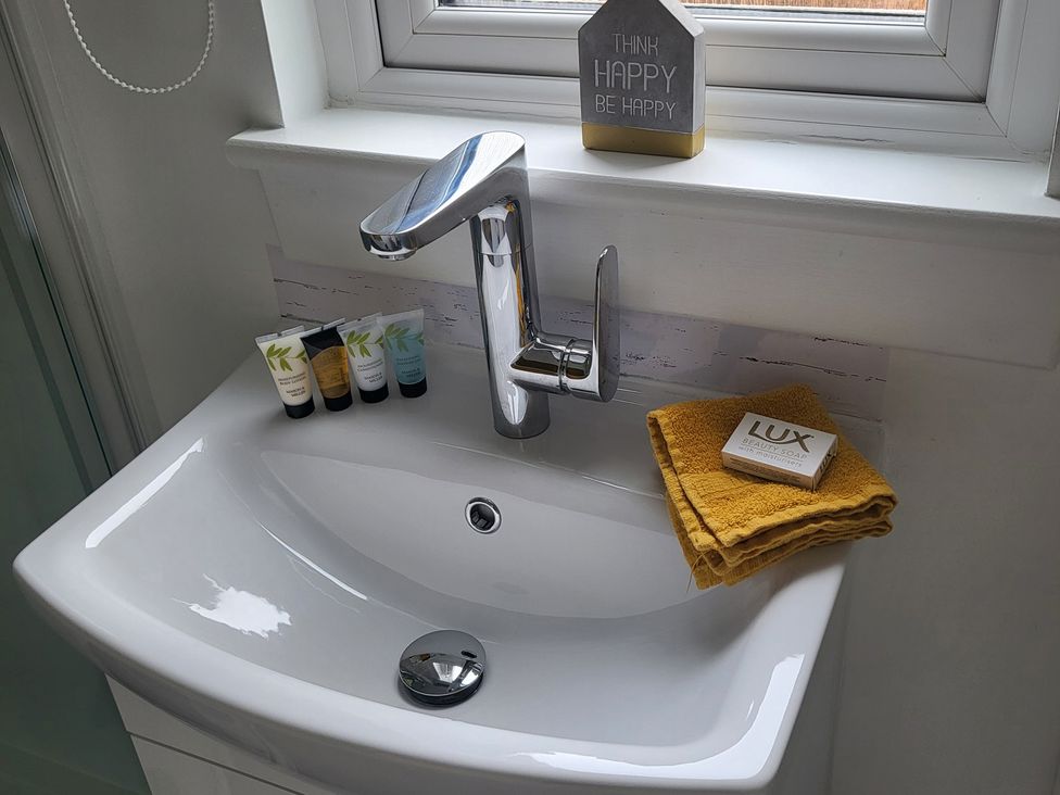 A sink with toiletries and a decorative sign at Taigh Nam Moireach in Inverness