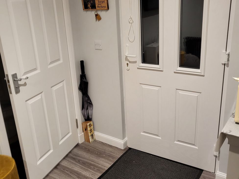 A hallway with a door and an umbrella at Taigh Nam Moireach in Inverness