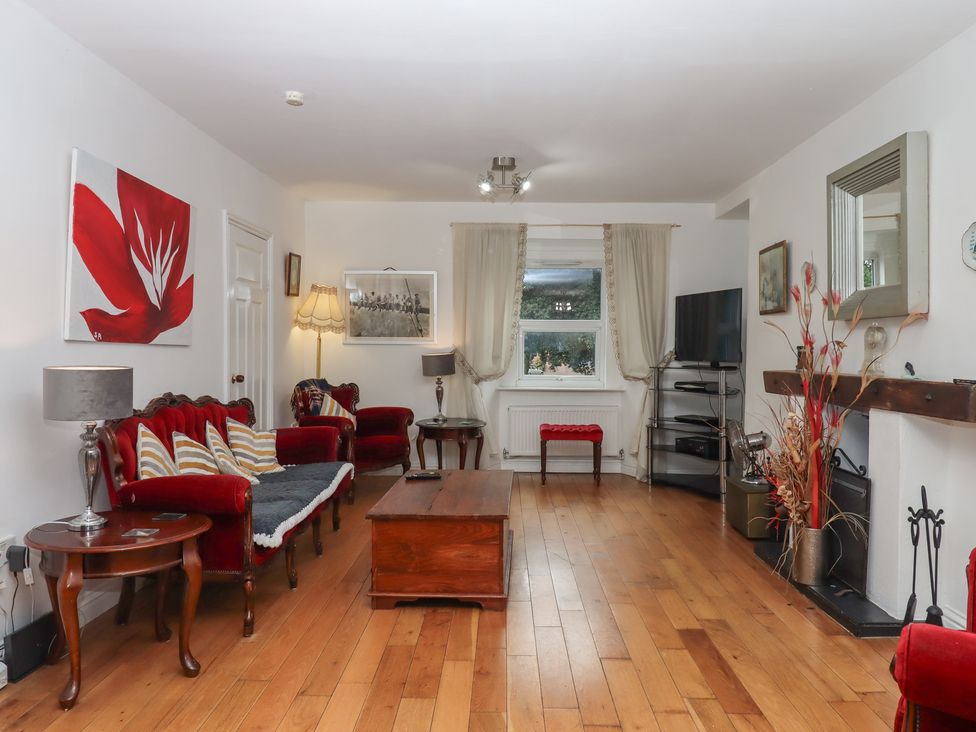 A living room with a sofa and TV at Teign Place Teignmouth