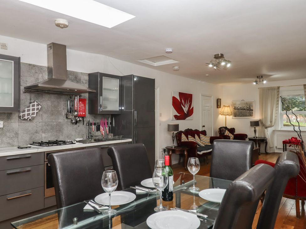 A kitchen and dining area with a table and chairs at Teign Place in Teignmouth