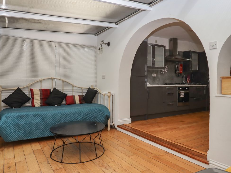 A kitchen with a couch and coffee table at Teign Place in Teignmouth