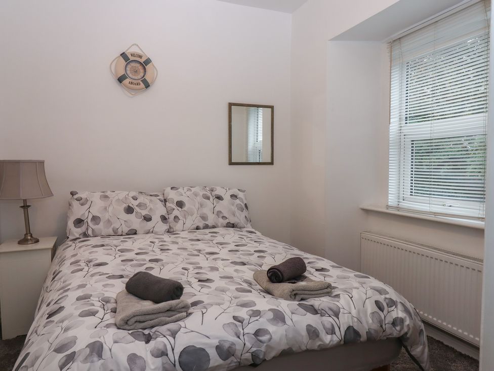 A bedroom with a bed and towels on the covers at Teign Place in Teignmouth