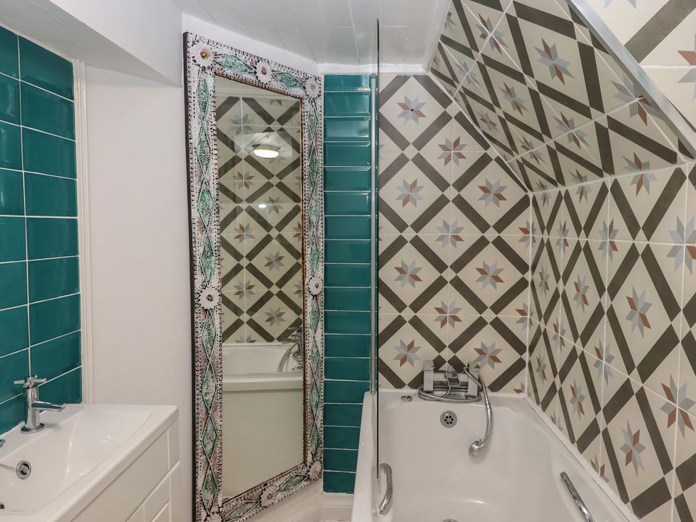 A bathroom with a bathtub and sink at Teign Place in Teignmouth