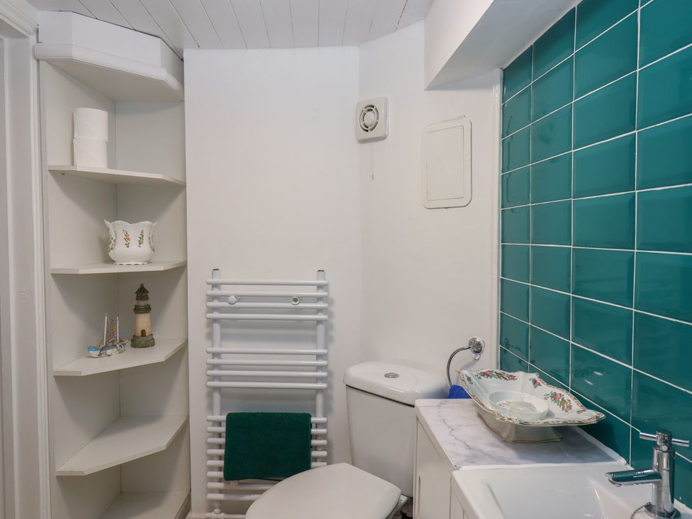 A bathroom with a toilet and sink at Teign Place in Teignmouth