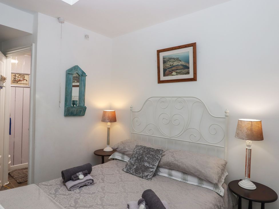 A bedroom with a bed and bedside table at Teign Place in Teignmouth