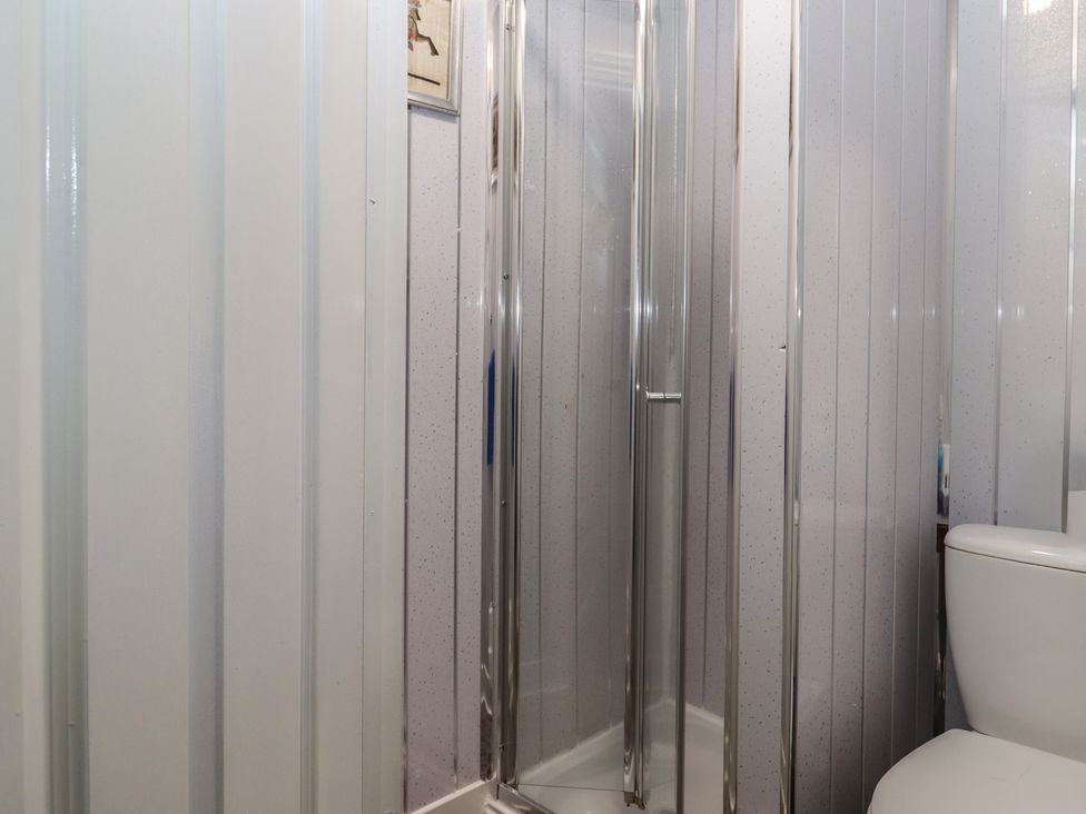 A bathroom with a shower and toilet at Teign Place in Teignmouth