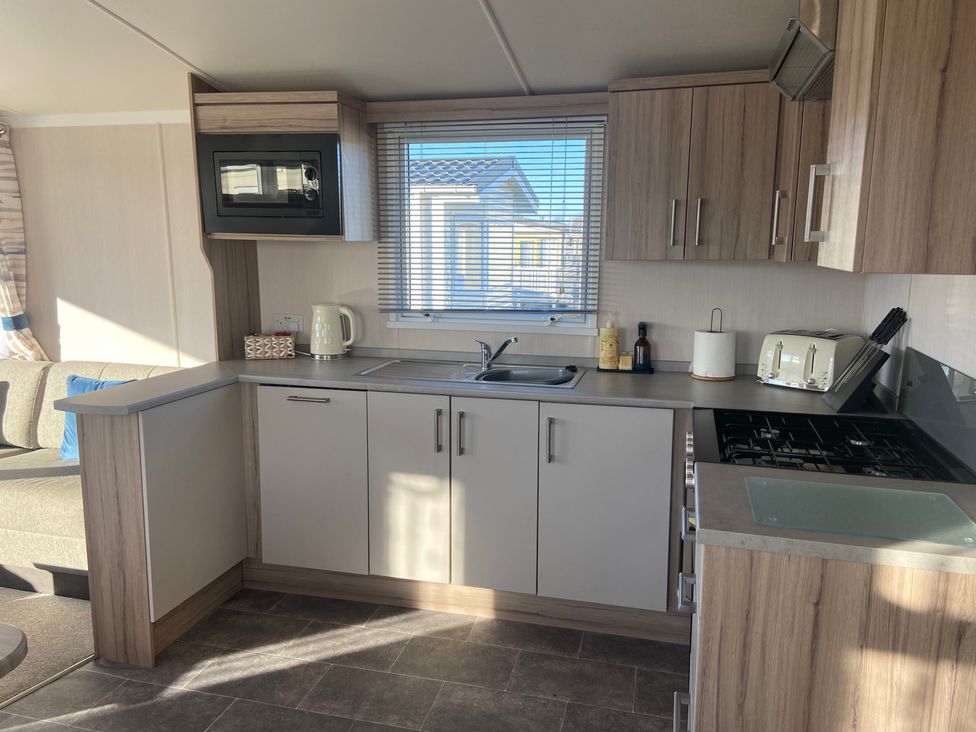 A kitchen with a sink and stove at Elms 32 Porthcawl