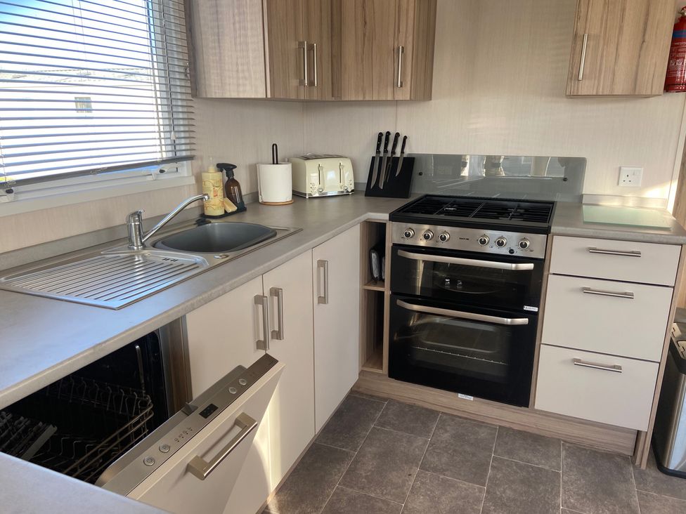 A kitchen with sink and oven at Elms 32 in Porthcawl