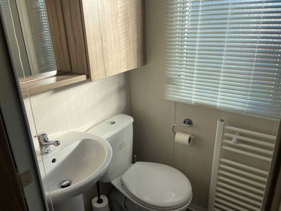 A bathroom with a toilet and wash basin at Elms 32 in Porthcawl