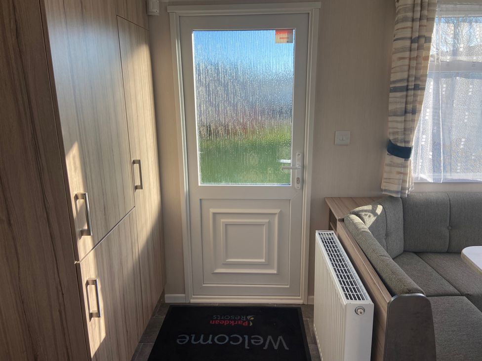 An entrance with a door and a cabinet at Elms 32 Porthcawl