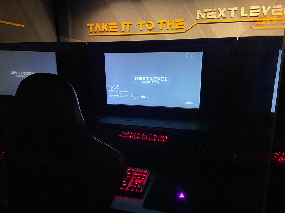 A gaming setup with a monitor and keyboard at Elms 32 in Porthcawl