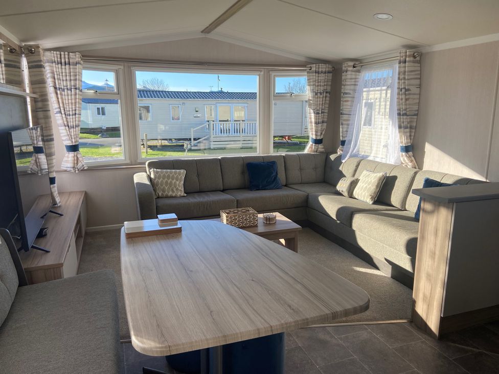 A living room with a sofa and coffee table at Elms 32 in Porthcawl