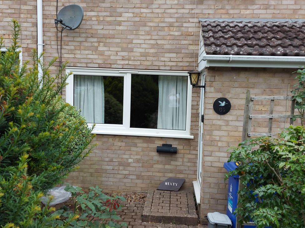 An exterior view of a house with a mailbox and plants at 60 Pond Bank in Northampton