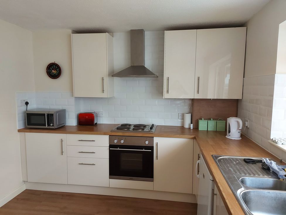 A kitchen with a microwave and stove at 60 Pond Bank Northampton