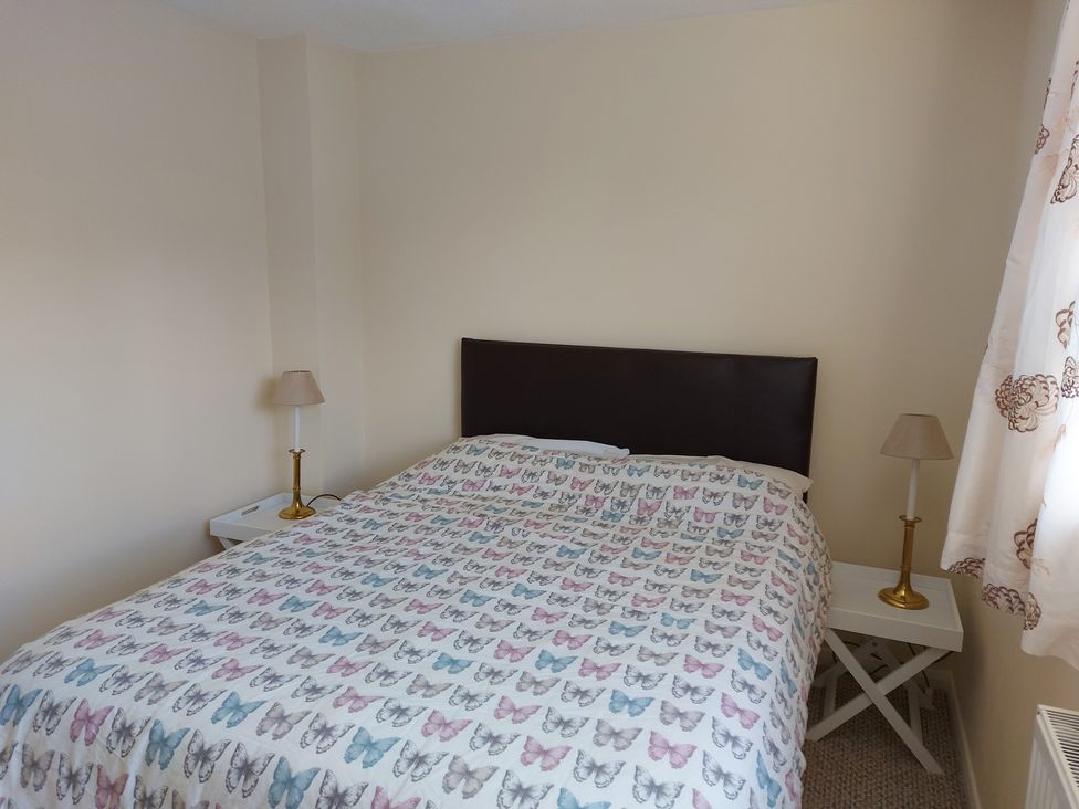 A bedroom with a bed and bedside tables in 60 Pond Bank Northampton