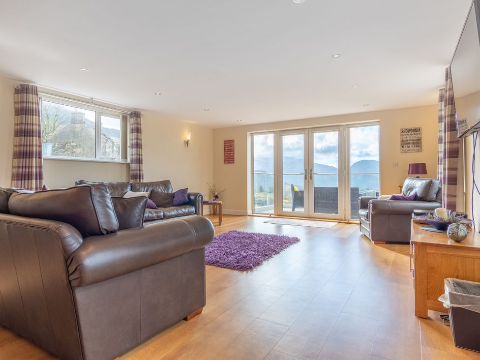 A living room with a sofa and coffee table at Groeslon Uchaf in Caernarfon