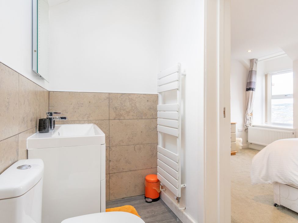 A bathroom with a toilet and sink at Groeslon Uchaf in Caernarfon