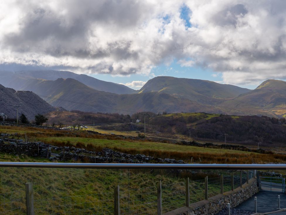 A view of mountains and grassland at Groeslon Uchaf in Caernarfon