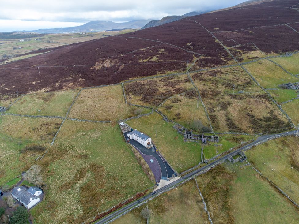 An overview of a house and surrounding fields at Groeslon Uchaf in Caernarfon