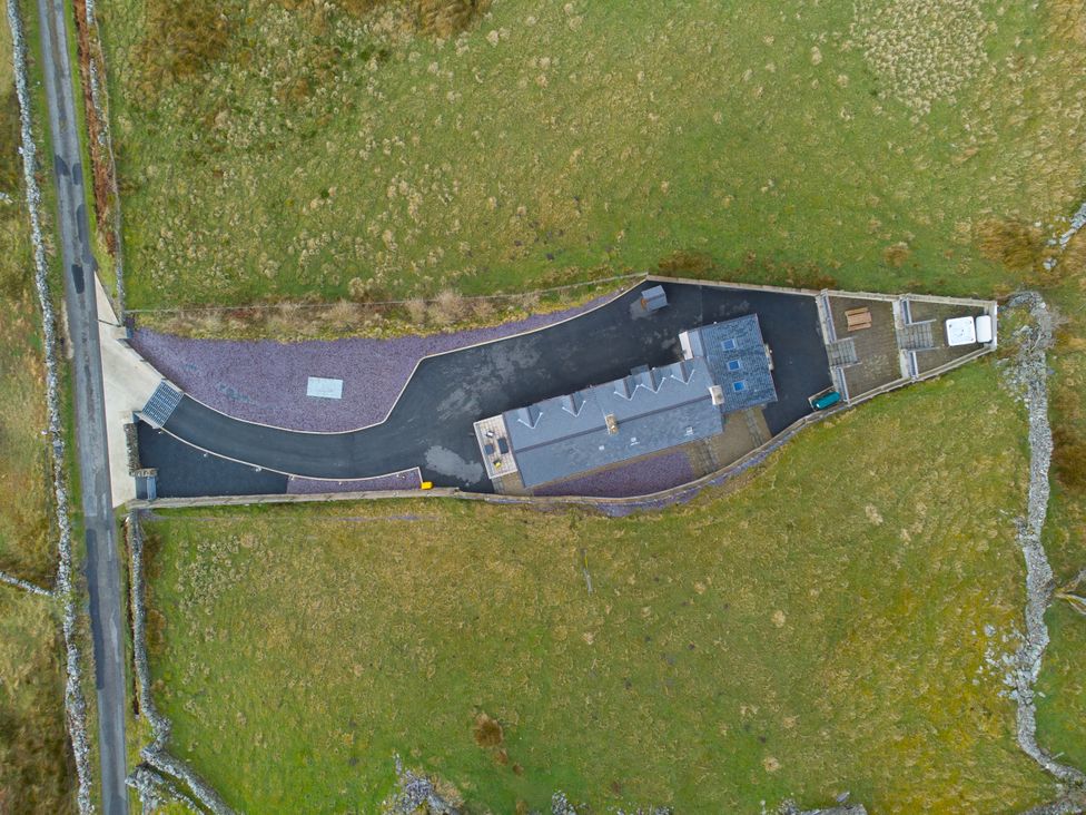 An aerial view of a property with driveway and surrounding fields at Groeslon Uchaf in Caernarfon