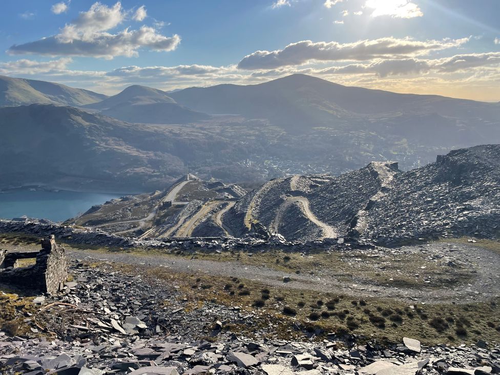 A view of mountains and a path leading to a lake at Groeslon Uchaf in Caernarfon