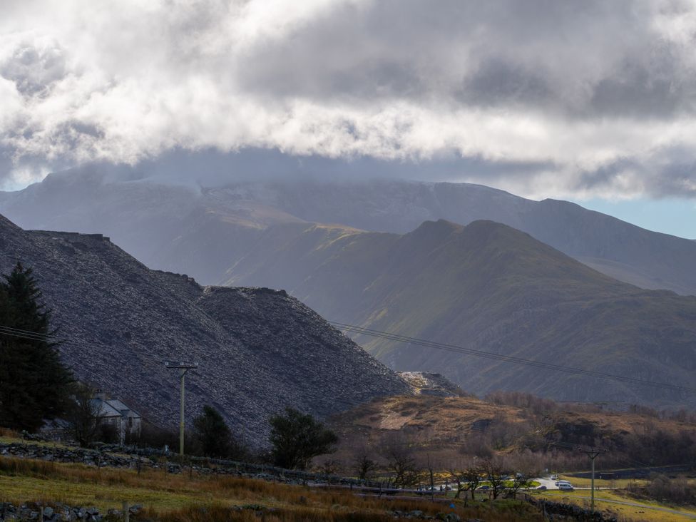 A landscape with mountains and a road at Groeslon Uchaf Caernarfon