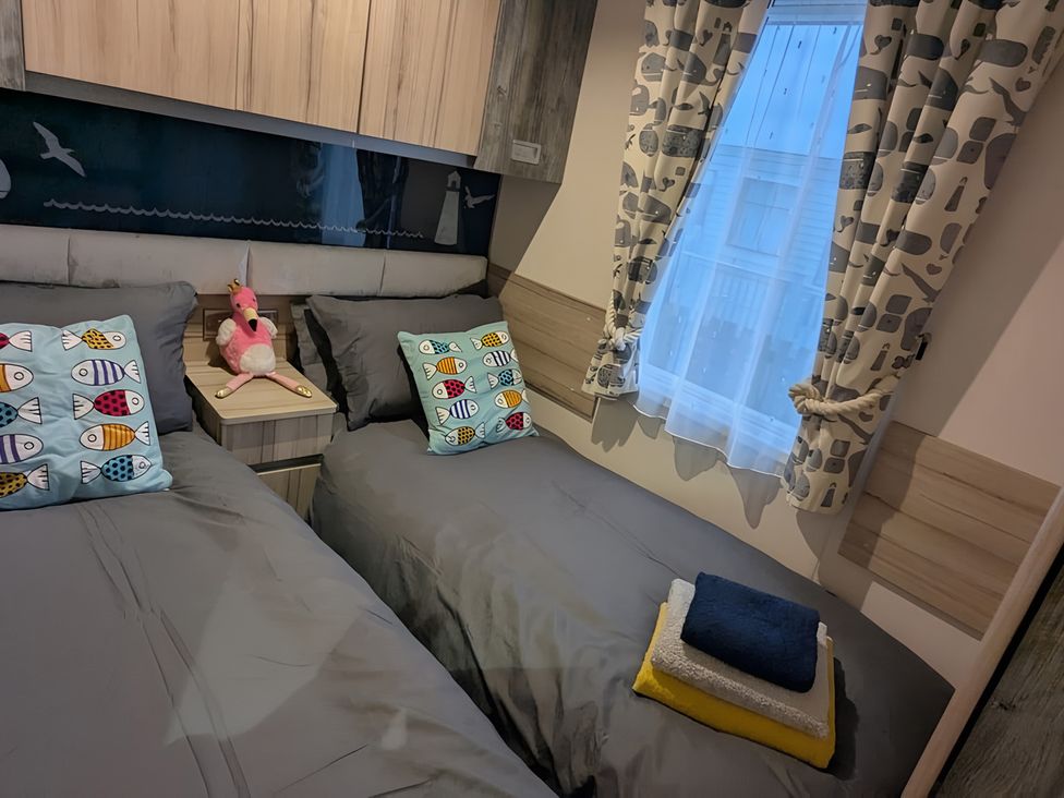 A bedroom with two beds and pillows at Lighthouse Lodge in Mablethorpe
