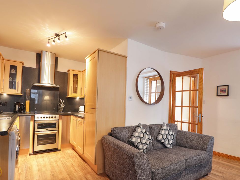 A kitchen with a sofa and cabinets at 1 Roseneath Terrace Nairn