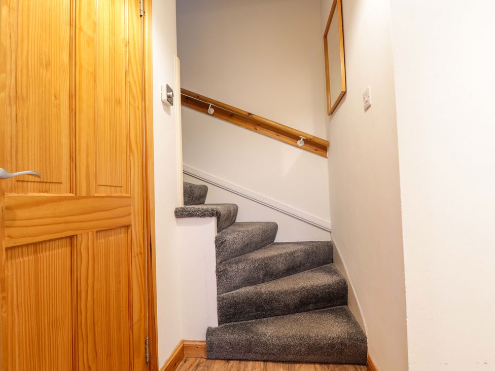 A staircase with a door and handrail at 1 Roseneath Terrace Nairn