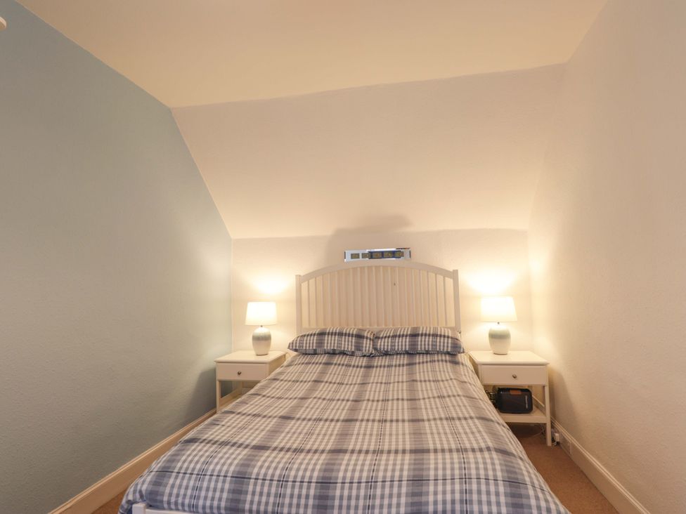 A bedroom with a bed and nightstands at 1 Roseneath Terrace Nairn