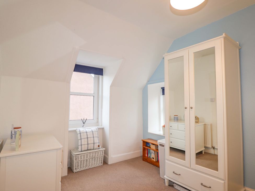 A bedroom with a wardrobe and chest of drawers at 1 Roseneath Terrace Nairn