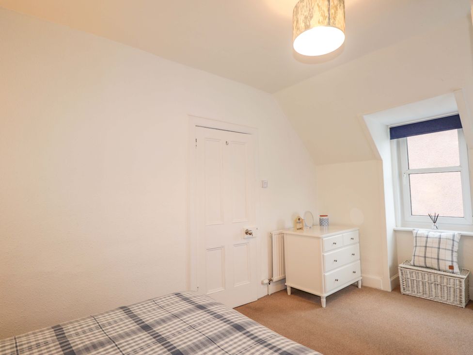 A bedroom with a bed and furniture at 1 Roseneath Terrace Nairn