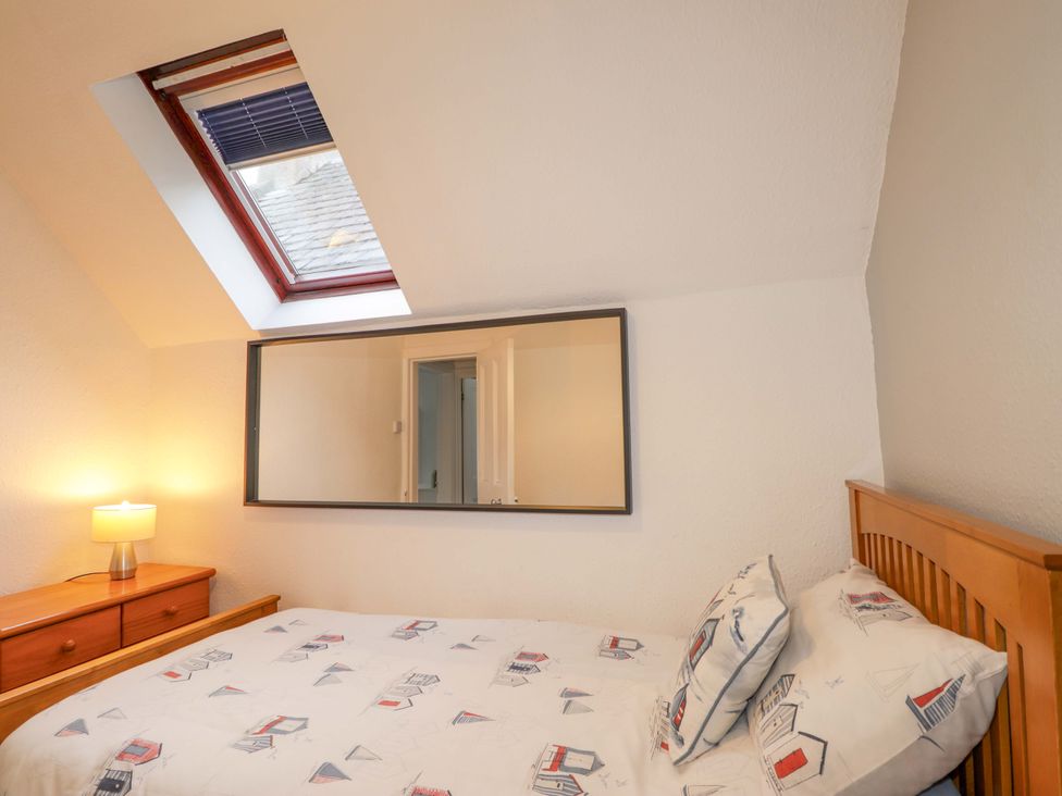A bedroom with a bed and a mirror at 1 Roseneath Terrace Nairn