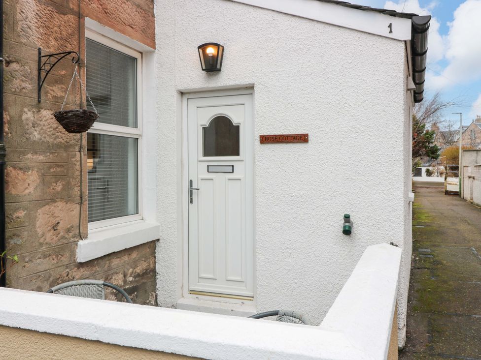 An entrance with a front door and sign at Rose Cottage in Nairn