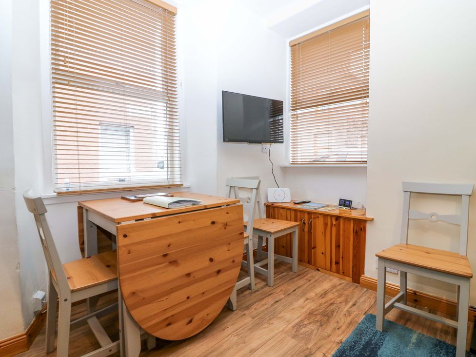 A dining room with a table and chairs at Rose Cottage Nairn