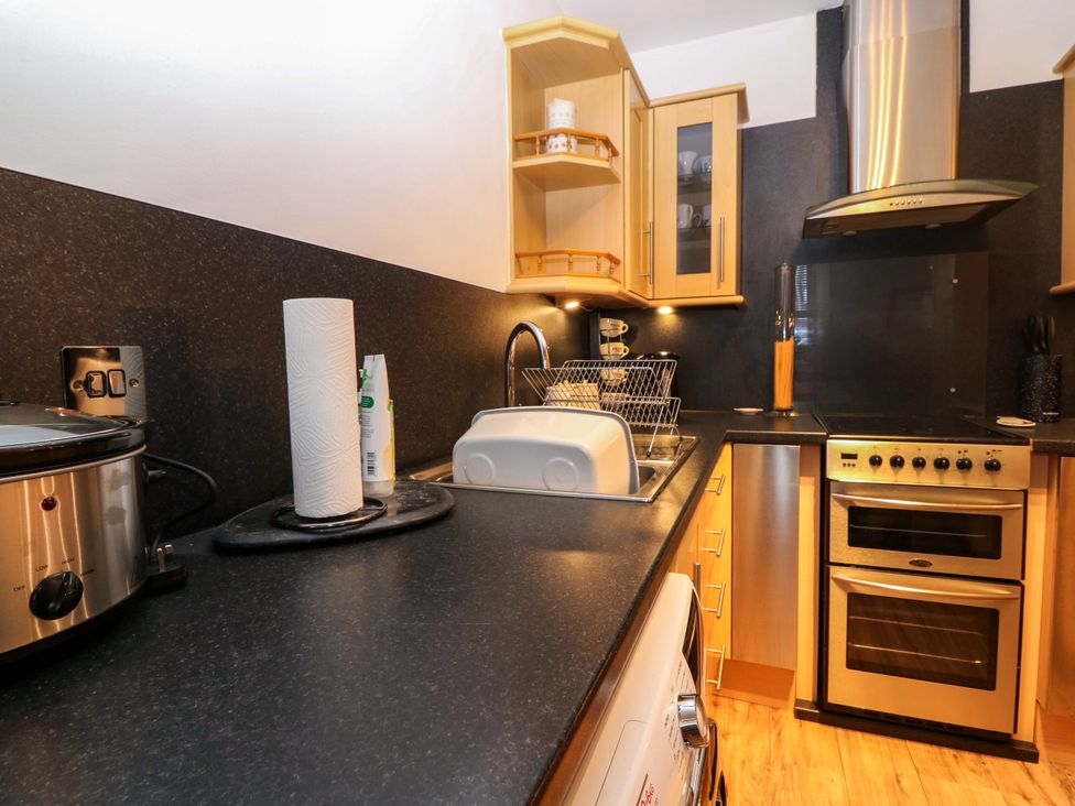 A kitchen with a sink and crockpot at Rose Cottage in Nairn