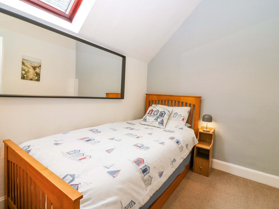 A bedroom with a single bed and a bedside table at Rose Cottage in Nairn