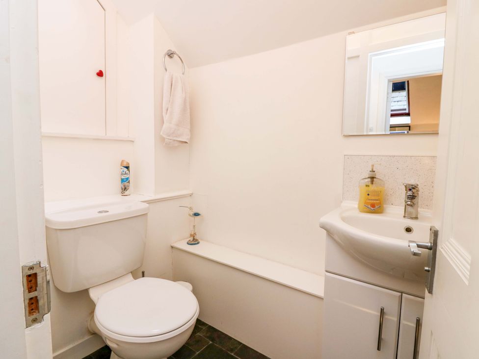 A bathroom with a toilet and sink at Rose Cottage in Nairn