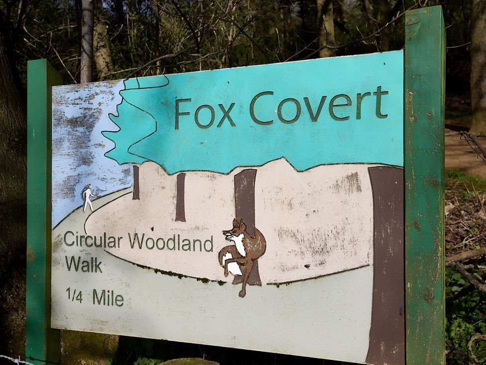 A sign for Fox Covert Circular Woodland Walk indicating 1/4 Mile