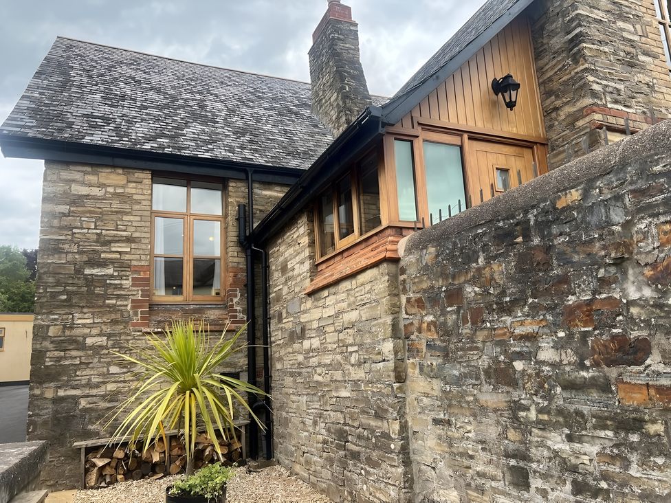 An exterior view of a stone house with a plant in front at 4 Bickington Road Barnstaple
