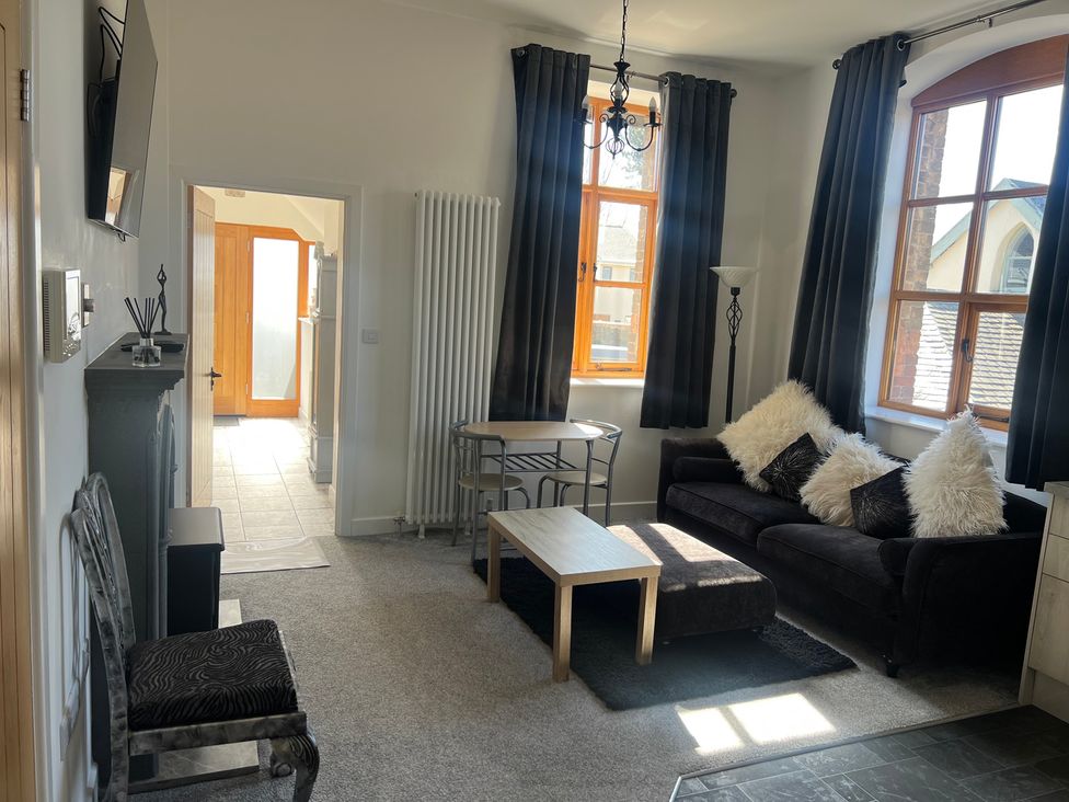 A living room with a sofa and coffee table at 4 Bickington Road in Barnstaple